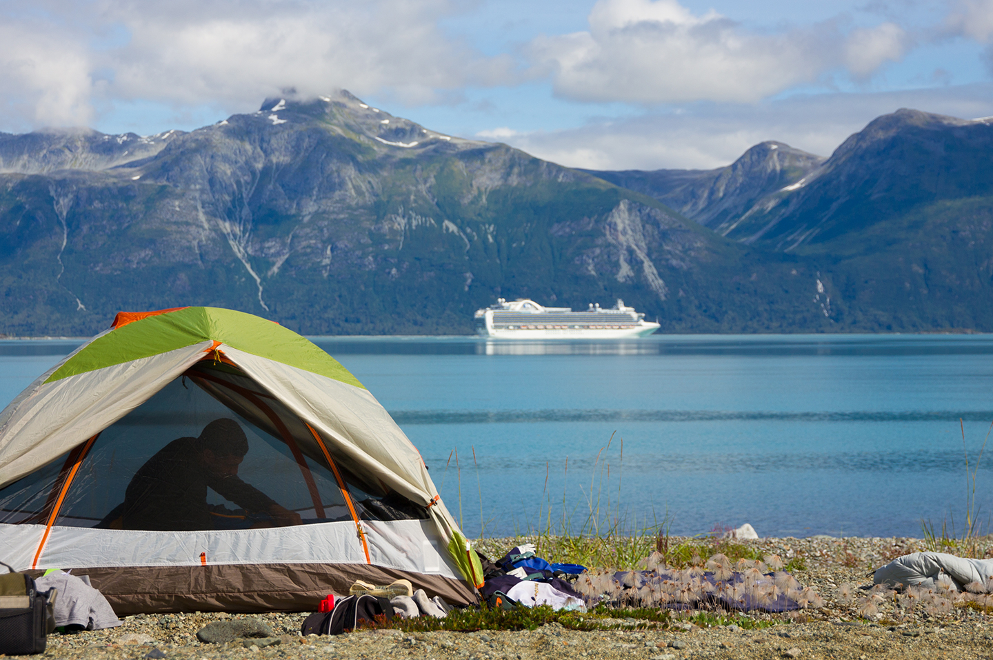 A tent erected next to a beautiful lake in Alaska