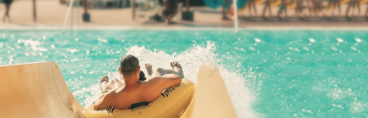 man at water park on water slide