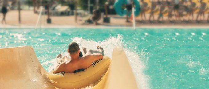 man at water park on water slide
