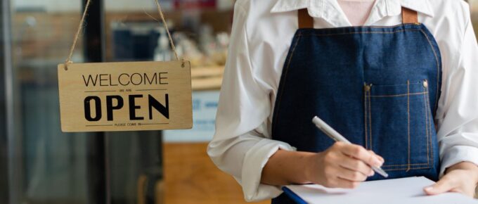 A girl holding a menu Food with an open sign beside a beverage restaurant opening concept.