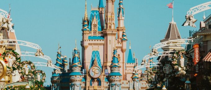A crowd of people in front of Castle in Disney World Florida.