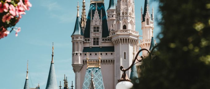 Close-up of Disneyland Castle with flowers and topiary
