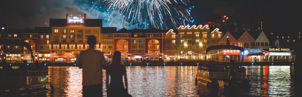 A couple watching the fireworks at Disney World's Deluxe Boardwalk Inn Resort