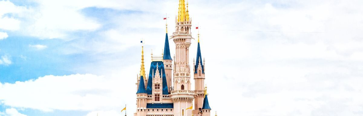 Walt Disney castle under a cloudy sky.