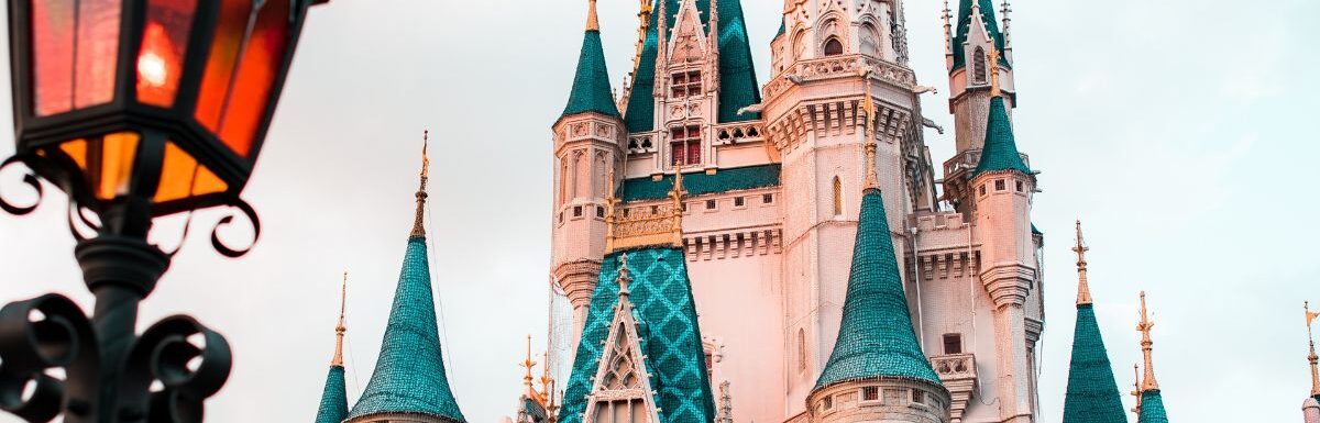 White and blue castle during the day at Disney World.