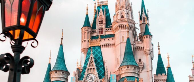 White and blue castle during the day at Disney World.