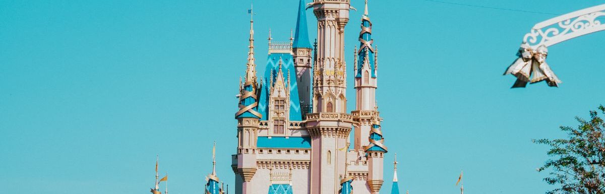 A castle in Disney World under a blue sky.