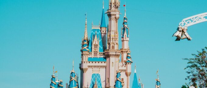 A castle in Disney World under a blue sky.