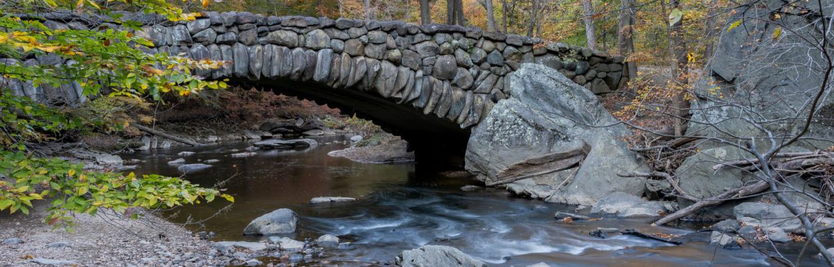 An autumn view of the Boulder Bridge in Rock Creek Park, Washington, DC.