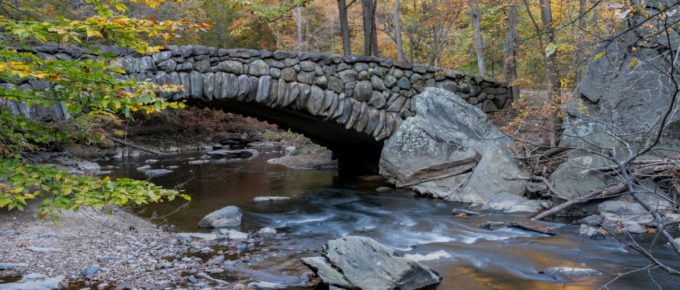 An autumn view of the Boulder Bridge in Rock Creek Park, Washington, DC.