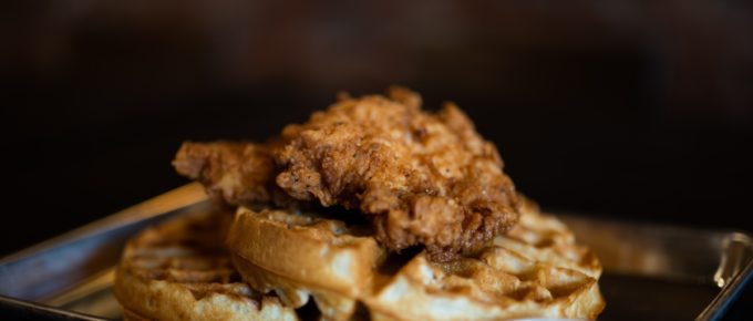 Delicious chicken and waffles with syrup.