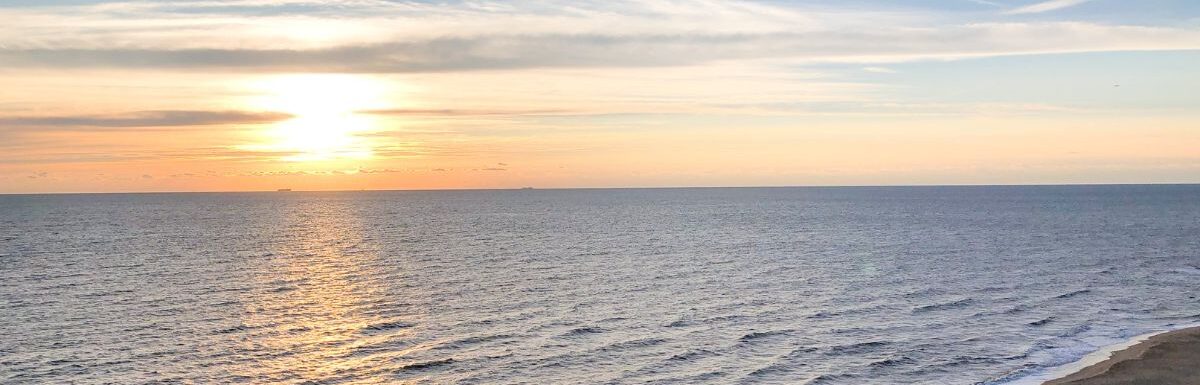 Ocean waves crashing on shore during sunset in Virginia Beach.
