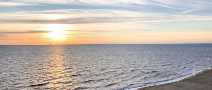 Ocean waves crashing on shore during sunset in Virginia Beach.