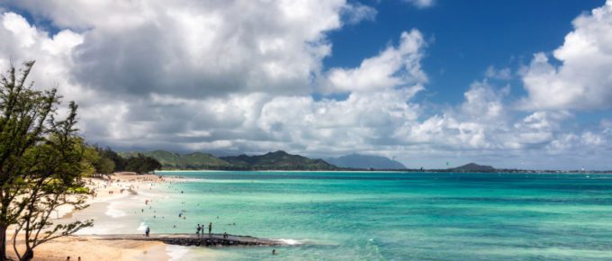 View of Kailua beach in Hawaii with lots of people sunbathing and swimming.