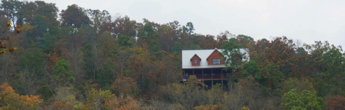 A cabin seen through in the forest on a beautiful autumn day.