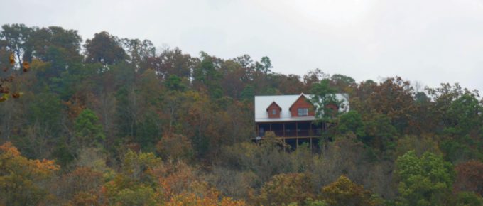 A cabin seen through in the forest on a beautiful autumn day.