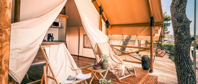 White and brown patio umbrella with chairs that can also be used for glamping.