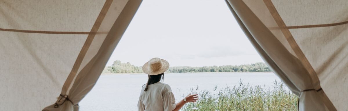 Woman wearing white dress while glamping.