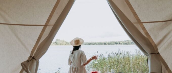 Woman wearing white dress while glamping.