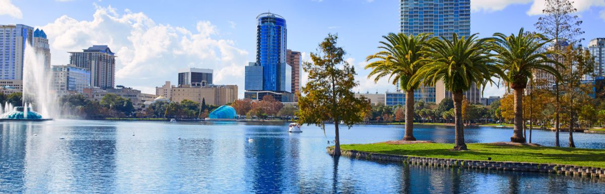 Orlando skyline from lake Eola in Florida USA with palm trees.