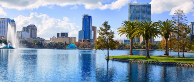 Orlando skyline from lake Eola in Florida USA with palm trees.