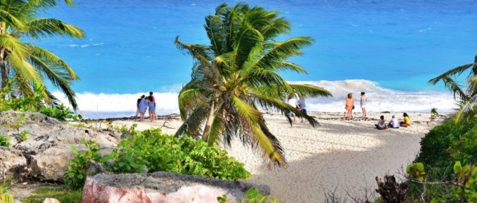 People enjoying the beach in Barbados during the daytime.