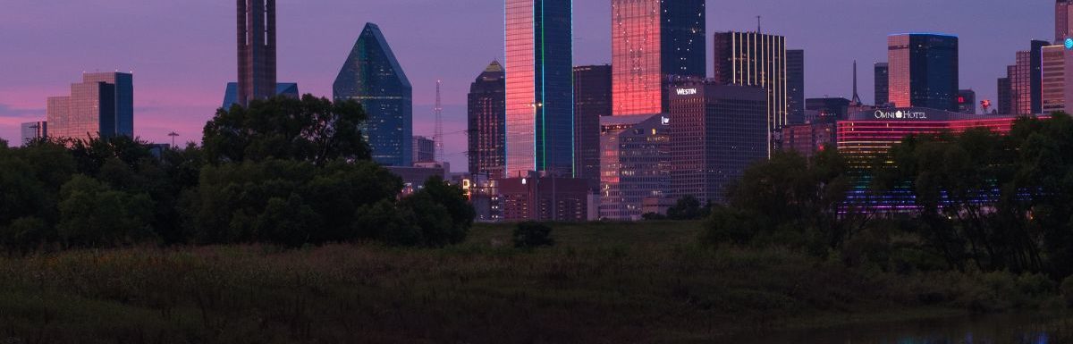 Evening sunset view of Downtown Dallas, Texas from across the Trinity River.
