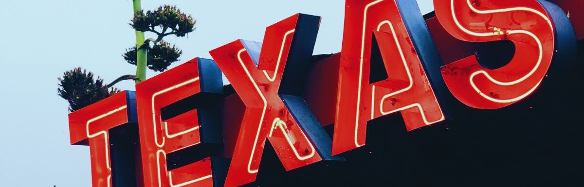 Red Texas all capital letters signage.