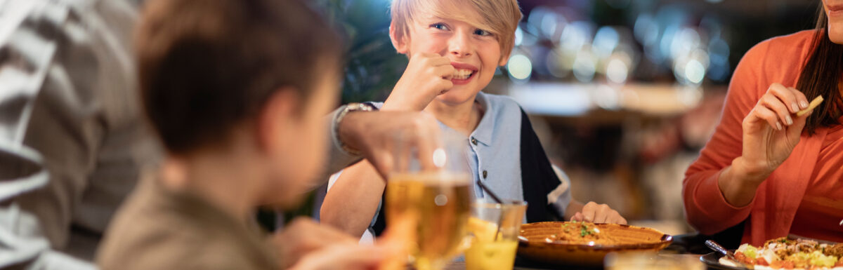 A family eating at a table at a restaurant.