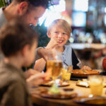 A family eating at a table at a restaurant.