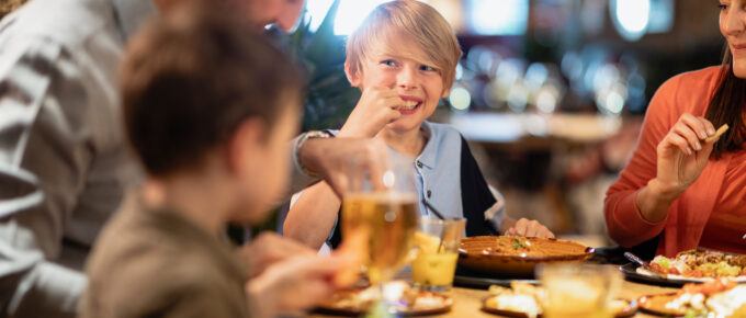 A family eating at a table at a restaurant.