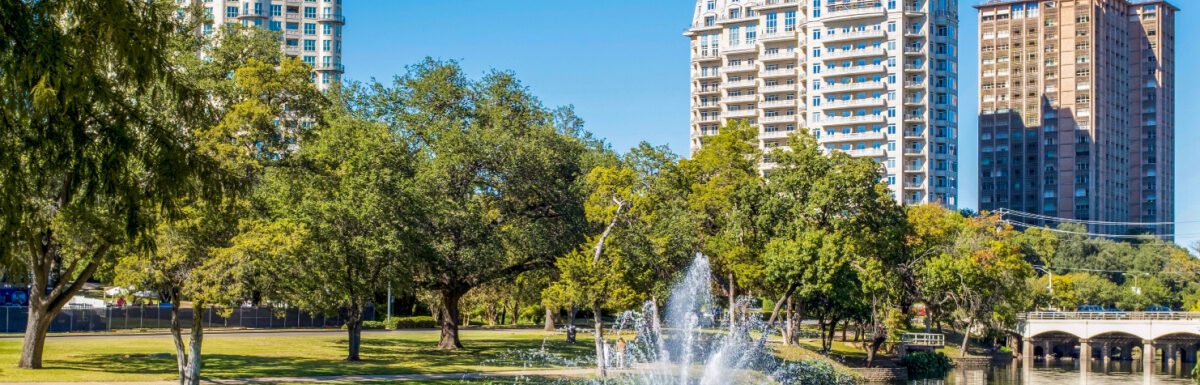 A photo of Turtle Creek with fountain and 3 residential buildings in Dallas, Texas, USA.