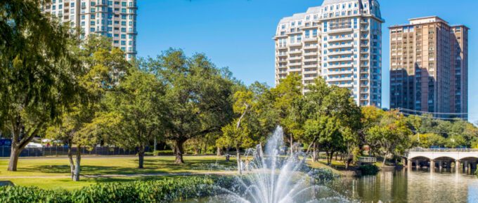 A photo of Turtle Creek with fountain and 3 residential buildings in Dallas, Texas, USA.