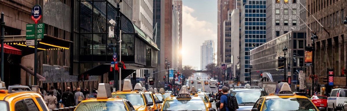 Yellow Taxi in Manhattan, New York City, USA during sunset.