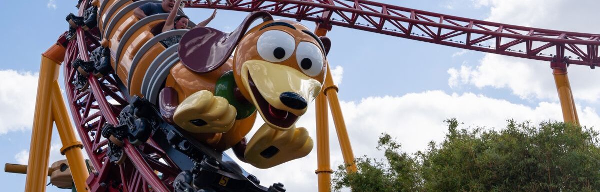 People enjoy the slinky dog dash attraction at Hollywood studios during a sunny day.