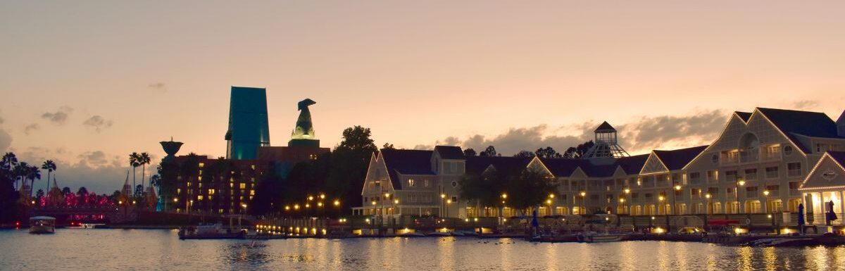 Taxi boat, colorful hotel and iluminated villas on sunset background, at Lake Buena Vista, Orlando, Florida, USA.