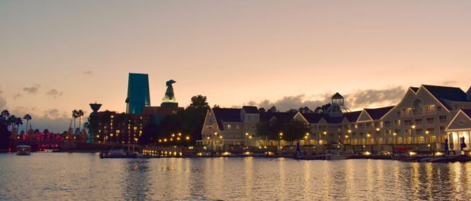 Taxi boat, colorful hotel and iluminated villas on sunset background, at Lake Buena Vista, Orlando, Florida, USA.