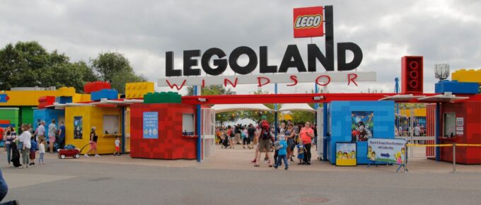 Entrance area of Legoland Windsor, UK with a lot of people around on a cloudy day.