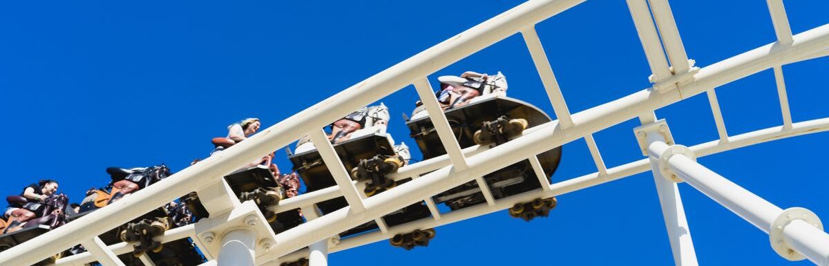 Low-angle view of people riding a roller coaster.