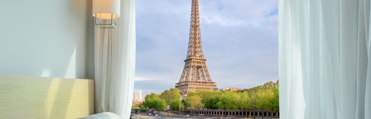 Beautiful Eiffel tower view at window in resort near Seine river, Paris, France.