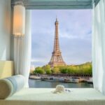 Beautiful Eiffel tower view at window in resort near Seine river, Paris, France.