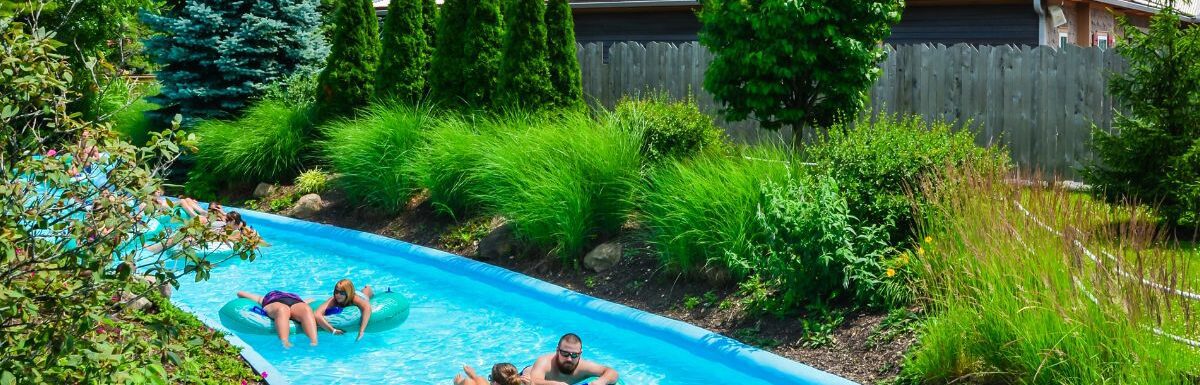 People floating on tubes along a lazy river ride during the day.