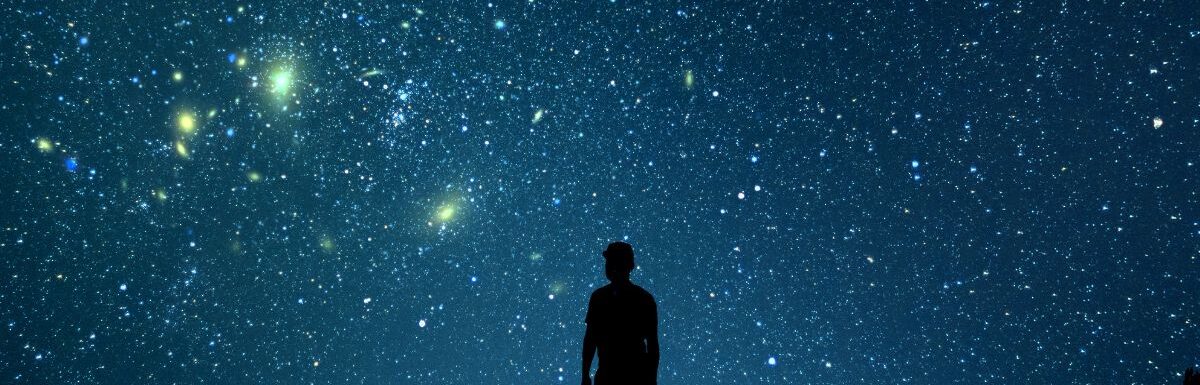 Alone man looking at a starry sky.