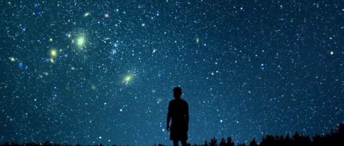 Alone man looking at a starry sky.